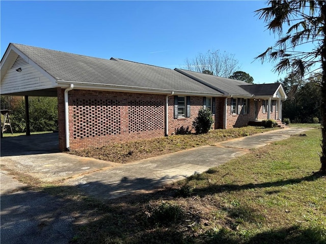 view of side of home with a carport