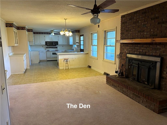 kitchen with white cabinets, a kitchen bar, range with two ovens, hanging light fixtures, and light carpet