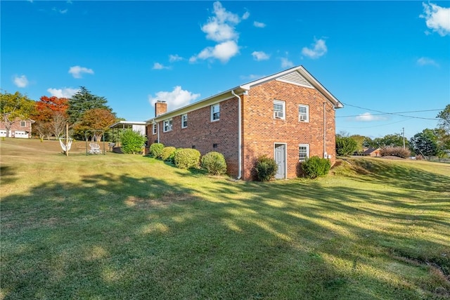 view of side of home with a lawn