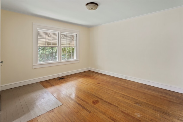 unfurnished room with hardwood / wood-style flooring