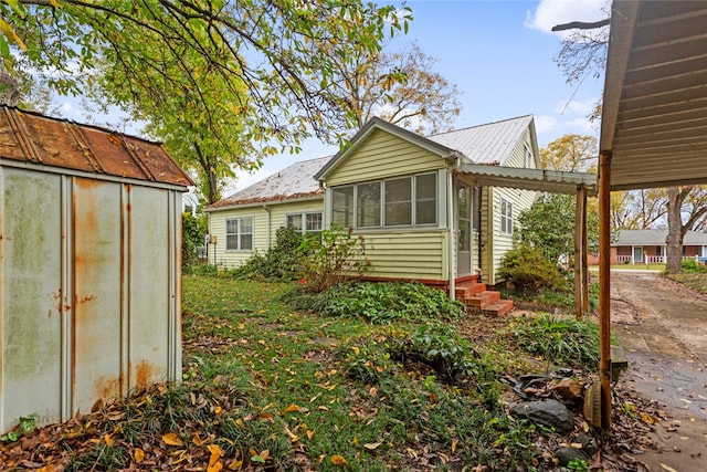 rear view of property featuring a shed