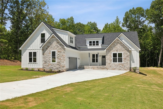 view of front of house with a garage and a front lawn