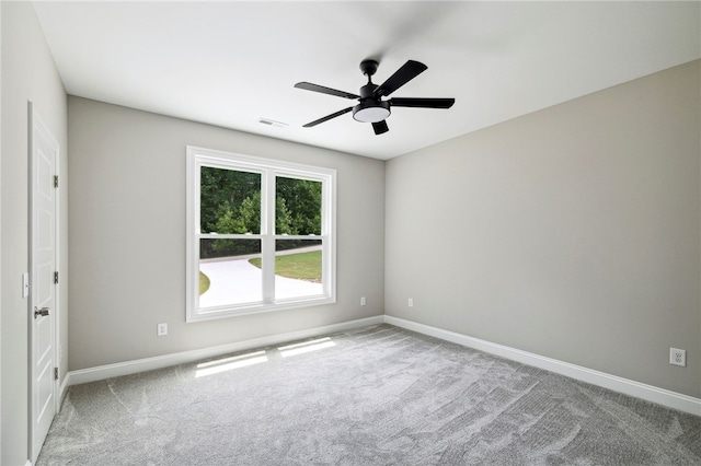 carpeted empty room featuring ceiling fan