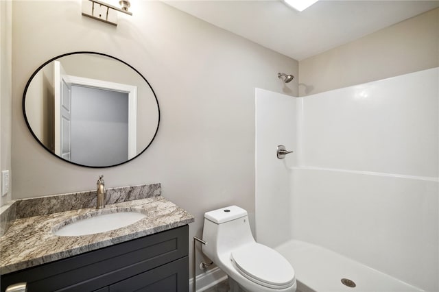 bathroom with toilet, a shower, and vanity