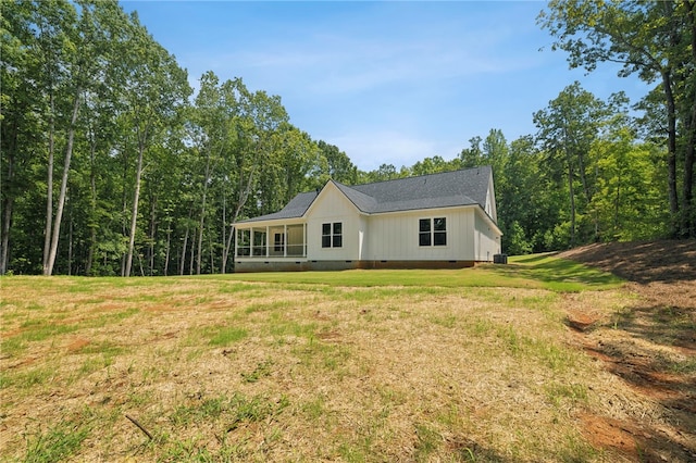 rear view of house with a yard