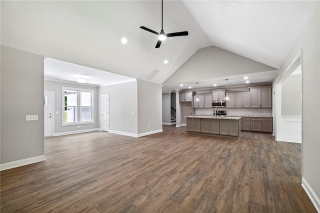 unfurnished living room featuring dark wood-type flooring, high vaulted ceiling, and ceiling fan