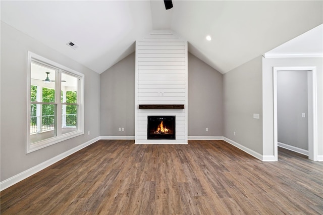 unfurnished living room with dark wood-type flooring, ceiling fan, lofted ceiling, and a large fireplace