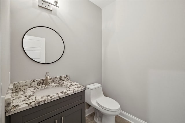 bathroom featuring toilet and vanity