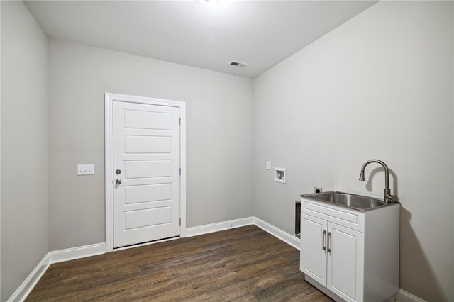 clothes washing area with cabinets, dark hardwood / wood-style flooring, hookup for a washing machine, and sink