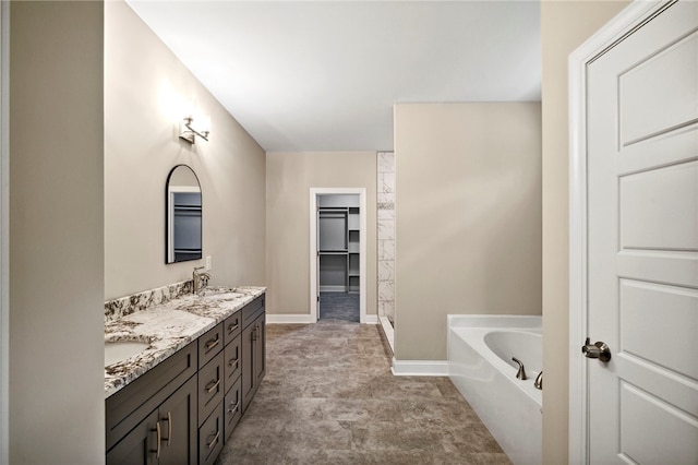 bathroom featuring vanity and a tub