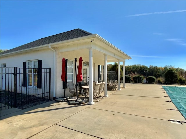 exterior space featuring a patio and a covered pool