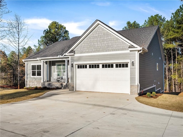 craftsman-style home featuring a garage and covered porch