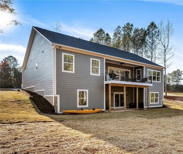 back of property featuring ceiling fan and a patio area