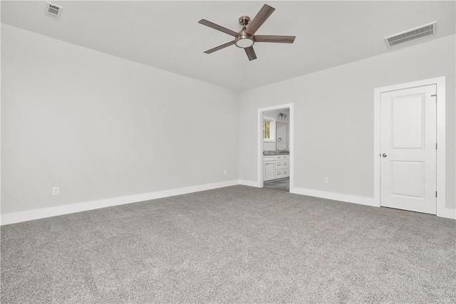 empty room featuring ceiling fan and carpet