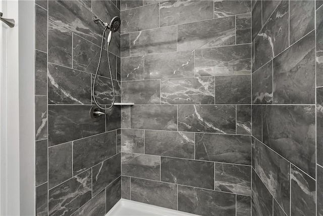 bathroom with a tile shower