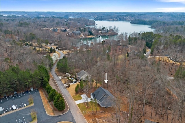 aerial view featuring a forest view and a water view