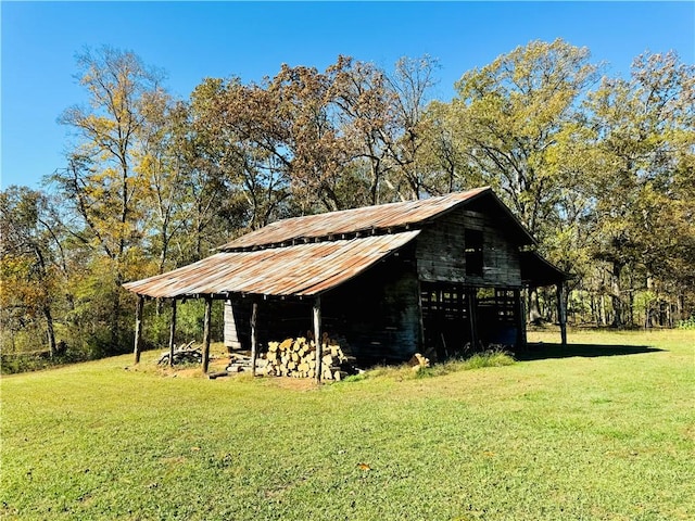 view of outdoor structure featuring a lawn