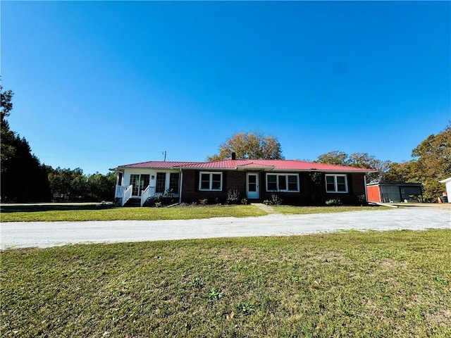 ranch-style home with a front lawn