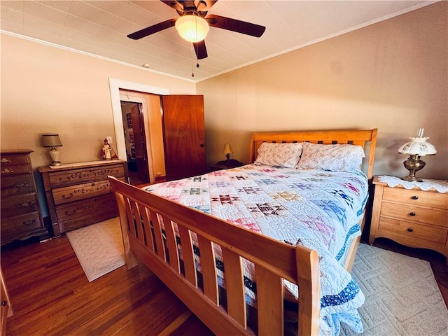 bedroom featuring ceiling fan, ornamental molding, and dark hardwood / wood-style flooring