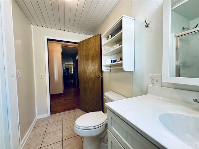 bathroom with toilet, wooden ceiling, vanity, a shower with door, and tile patterned flooring