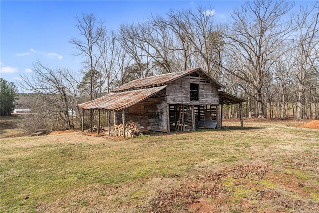 view of barn with a lawn