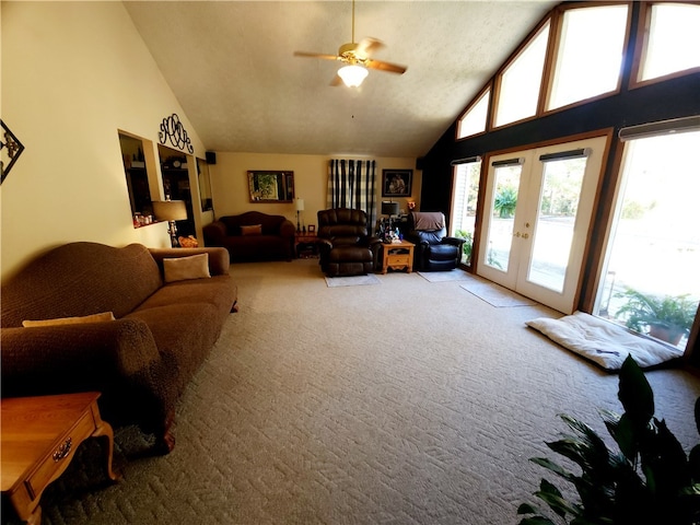 carpeted living room featuring ceiling fan, high vaulted ceiling, and french doors