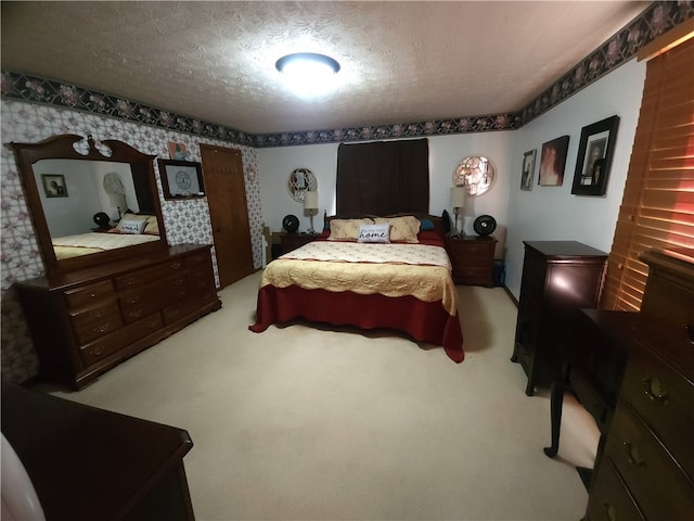 bedroom featuring carpet flooring and a textured ceiling