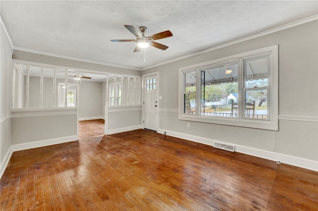 empty room featuring hardwood / wood-style flooring, ceiling fan, crown molding, and a textured ceiling