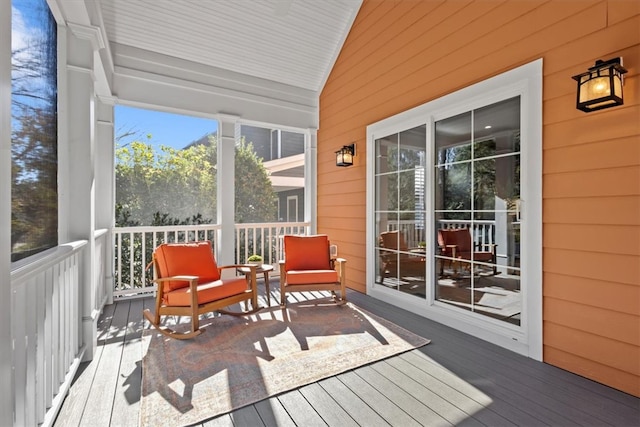 sunroom / solarium featuring vaulted ceiling