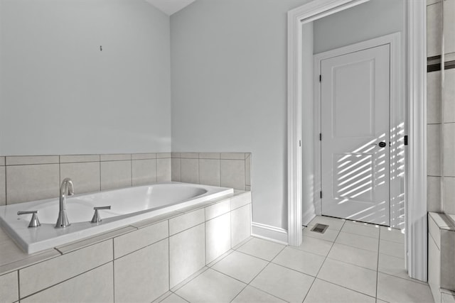 bathroom featuring tiled bath and tile patterned floors