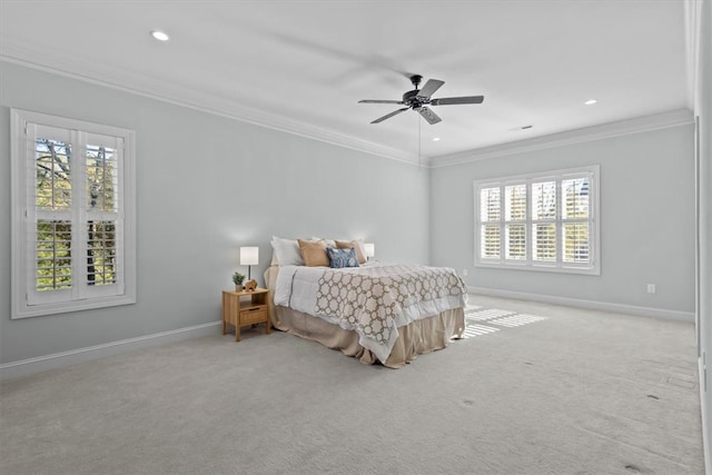 carpeted bedroom featuring ceiling fan, ornamental molding, and multiple windows