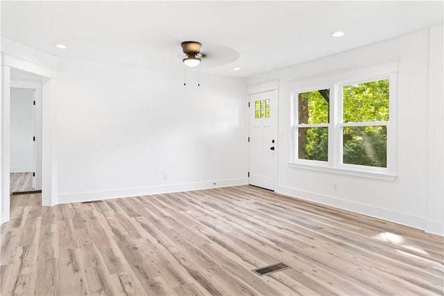 spare room with ceiling fan and light wood-type flooring