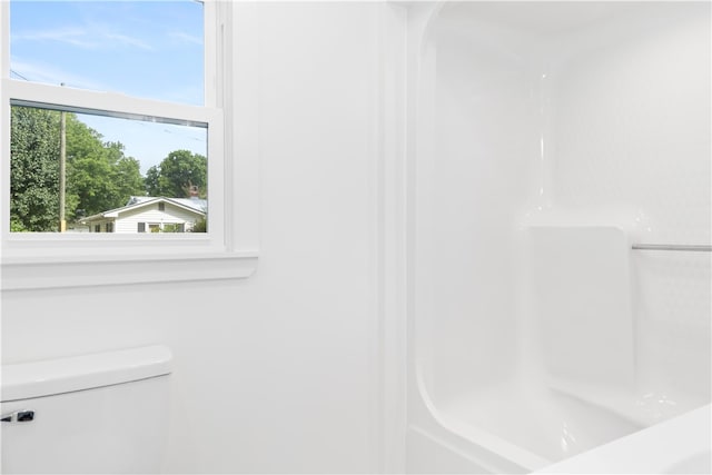 bathroom with a shower and toilet