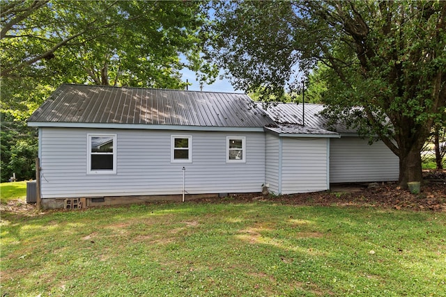 view of home's exterior with a yard and central AC unit