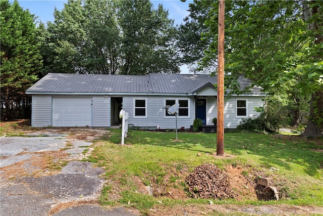 single story home featuring a front lawn and a garage