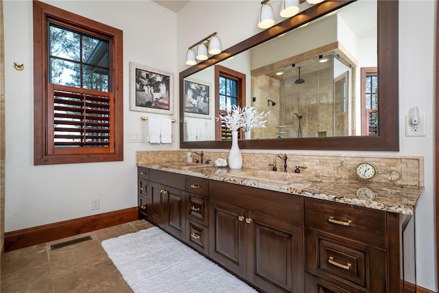 bathroom featuring tile patterned flooring, vanity, and walk in shower