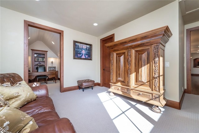 living room featuring carpet and vaulted ceiling