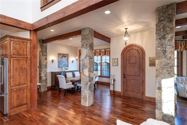 foyer entrance with beam ceiling and dark hardwood / wood-style flooring