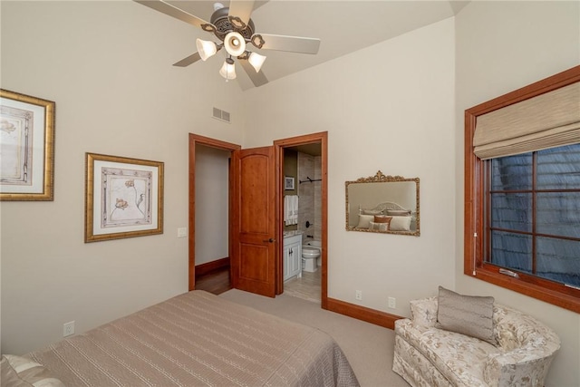 carpeted bedroom with connected bathroom, ceiling fan, and lofted ceiling