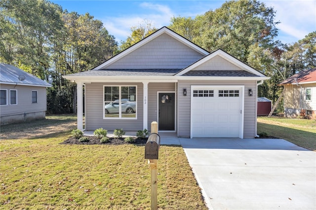 view of front of property with a front yard and a garage