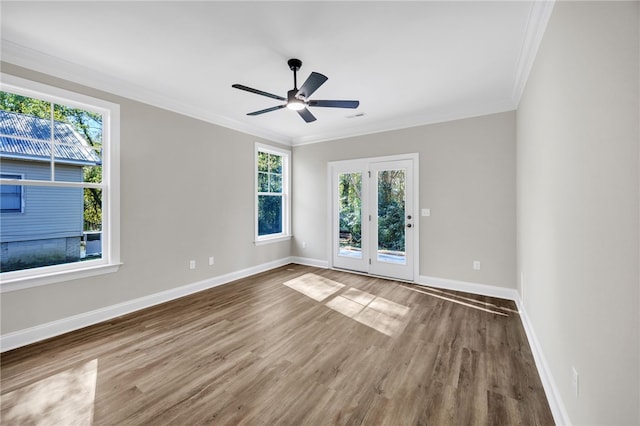 empty room featuring ceiling fan, hardwood / wood-style floors, and ornamental molding