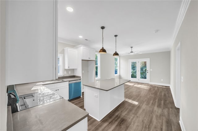 kitchen with dark wood-type flooring, white cabinetry, a center island, and stainless steel dishwasher