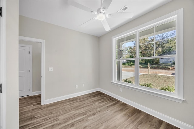 spare room with wood-type flooring and ceiling fan