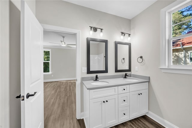 bathroom with wood-type flooring, vanity, and ceiling fan