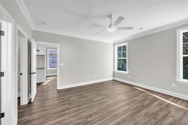 empty room with ceiling fan, dark hardwood / wood-style floors, and ornamental molding