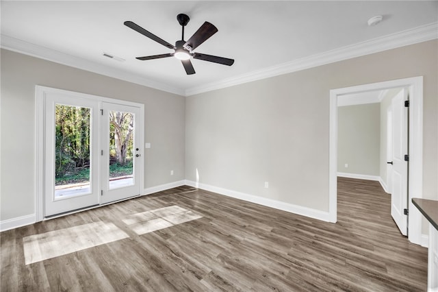 spare room featuring wood-type flooring, ceiling fan, and ornamental molding