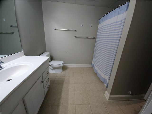 bathroom with a shower with curtain, vanity, toilet, and tile patterned floors