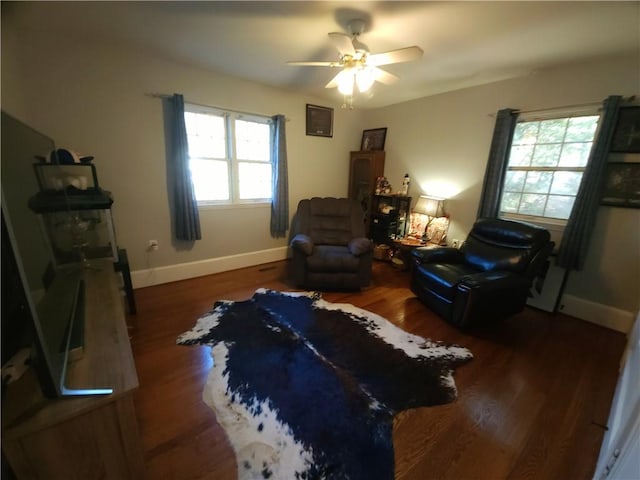 sitting room featuring dark hardwood / wood-style flooring and ceiling fan