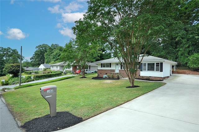 single story home featuring a carport and a front yard