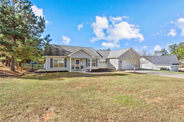 ranch-style house featuring a front lawn and a garage